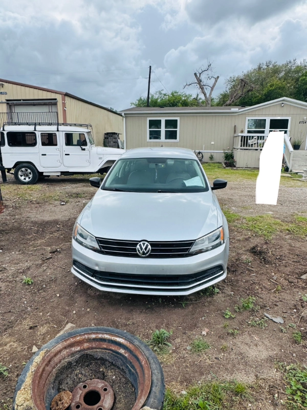 Non-running Volkswagen sedan parked in a Houston yard ready to be sold as-is for cash