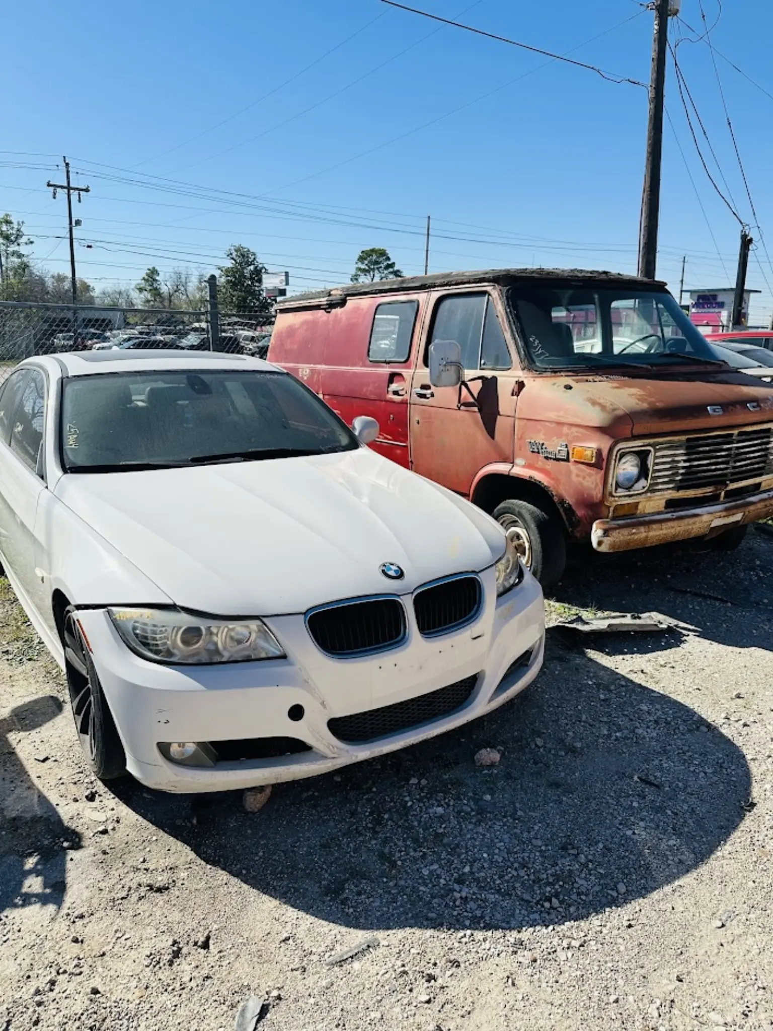 Damaged BMW sedan and aging work van ready to sell as-is, Zeus Cash For Junk Cars offers cash offers and free towing throughout Houston-area service regions.